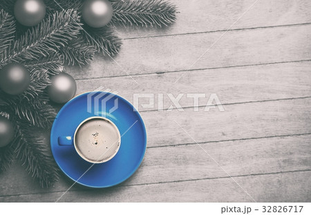 Cappuccino and  pine branch on wooden table. 32826717