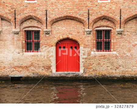 Red door and two windows at water canal 32827879