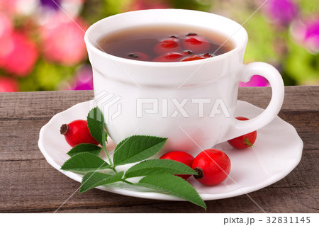 Tea from the hips on the wooden table with a 32831145