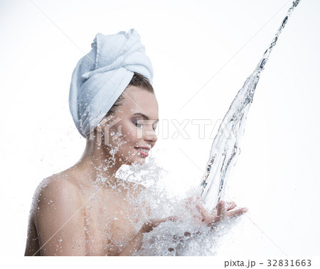 Happy girl and water stream falling to her hands Happy girl and water stream falling to her hands 32831663
