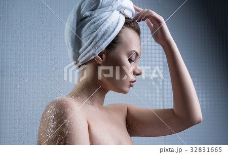 Girl with towel on her head and water drops around Girl with towel on her head and water drops around 32831665