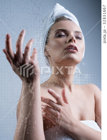 Young girl enjoying water splashes on her face Young girl enjoying water splashes on her face 32831667