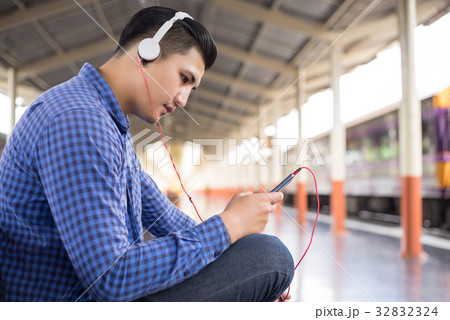 man traveler with backpacker listening to music man traveler with backpacker listening to music 32832324