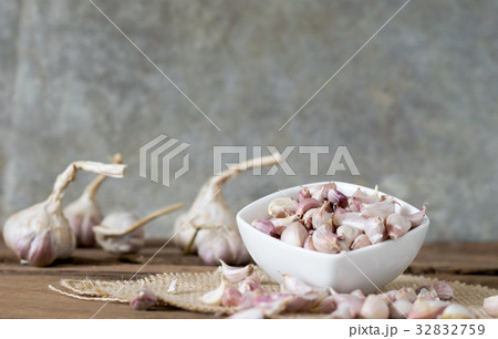 garlic on old wooden table with old wallpaper garlic on old wooden table with old wallpaper 32832759