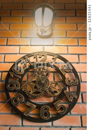 Vintage wall clock on brick room 32835341