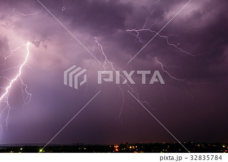 Thunderstorm with lightning in the sky over a town Thunderstorm with lightning in the sky over a town 32835784