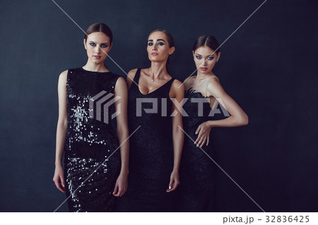 Attractive girls in black cocktail dresses on a Attractive girls in black cocktail dresses on a 32836425