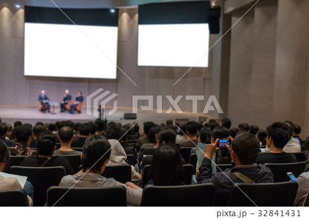 Rear view of Audience over the speakers on the stage in the conference hall or seminar meeting, business and education concept Rear view of Audience over the speakers on the stage in the conference hall or seminar meeting, business and education concept 32841431
