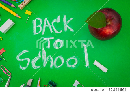 School supplies on Green chalkboard " Back to school background " . 32841661