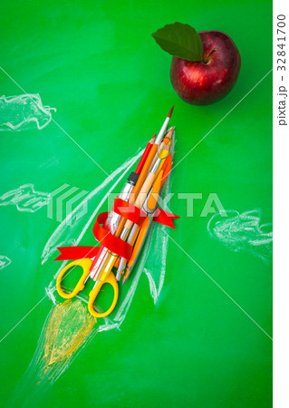 Rocket made from School supplies on Green chalkboard " Back to school background " . 32841700