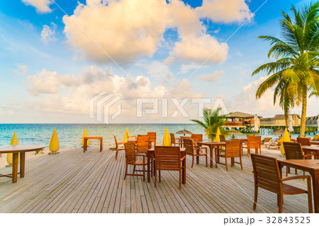 Table and chairs at restaurant in tropical Maldives island . 32843525