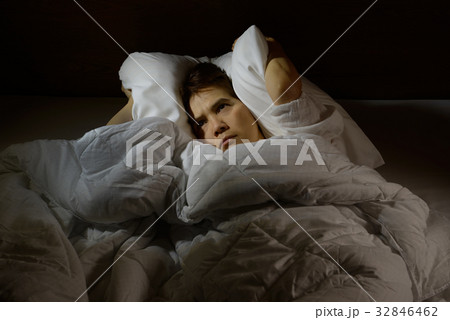 Woman with insomnia lying in bed with open eyes 32846462