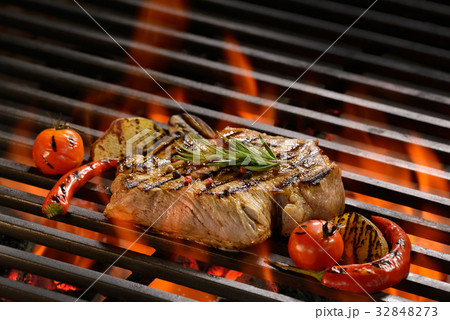 Grilled pork steak on the flaming grill 32848273