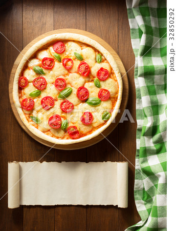 pizza at wooden table 32850292