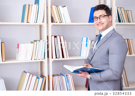 Businessman student reading a book studying in Businessman student reading a book studying in 32854333