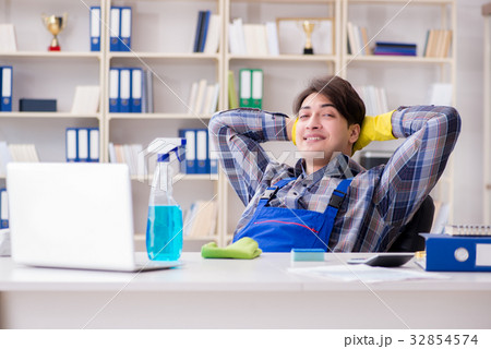 Male cleaner working in the office Male cleaner working in the office 32854574