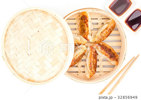 Gyoza dumplings in bamboo basket on a white Gyoza dumplings in bamboo basket on a white 32856949
