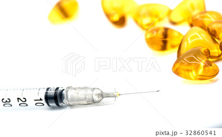 hypodermic syringe and pill, isolated on white  32860541