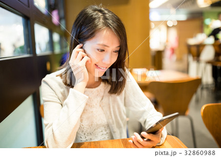 Woman reading something on mobile phone Woman reading something on mobile phone 32860988
