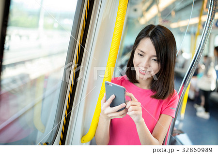 Woman use of cellphone inside train compartment Woman use of cellphone inside train compartment 32860989