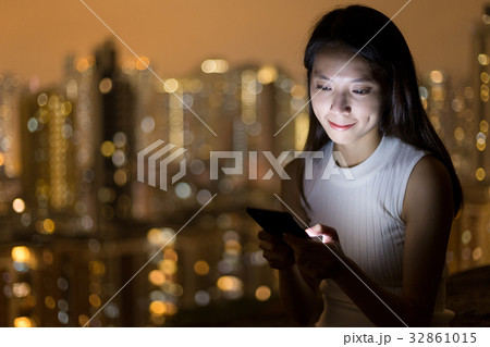 Woman use of cellphone at night Woman use of cellphone at night 32861015