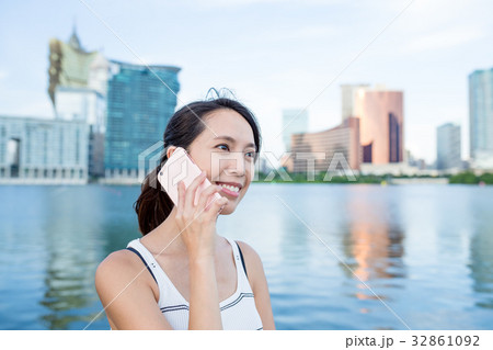 Woman talk to cellphone in Macau city Woman talk to cellphone in Macau city 32861092