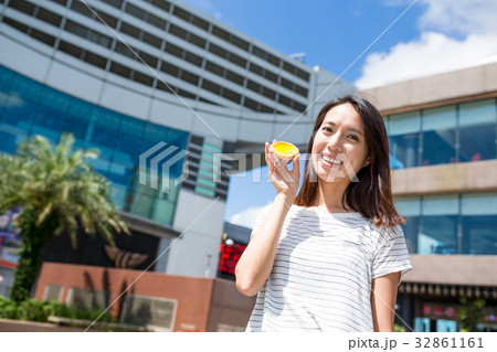 Woman holding famous Hong Kong local food, egg tart 32861161