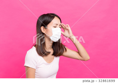 Woman wearing face mask and feeling unwell 32861699
