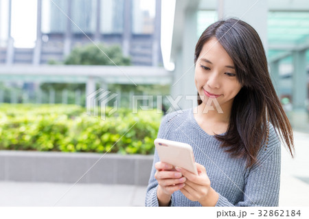 Woman using cellphone at outdoor Woman using cellphone at outdoor 32862184