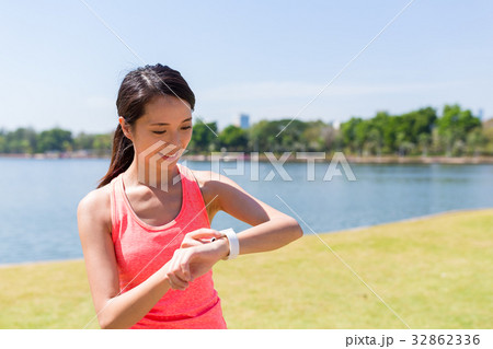 Woman using smart watch at outdoor park 32862336