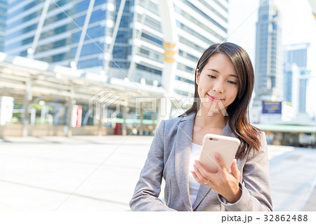 Businesswoman working on cellphone in bangkok city 32862488