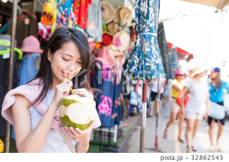 Woman drinking of coconut at street market 32862543