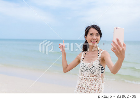 Young Woman taking selfie at sand beach 32862709