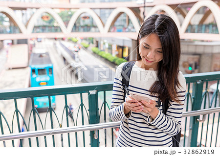 Woman using mobile phone in hong kong city Woman using mobile phone in hong kong city 32862919