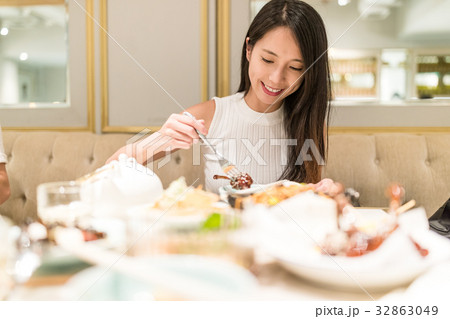 Woman having meal in restaurant Woman having meal in restaurant 32863049