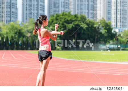 Sport woman stretching hand in sport stadium Sport woman stretching hand in sport stadium 32863054