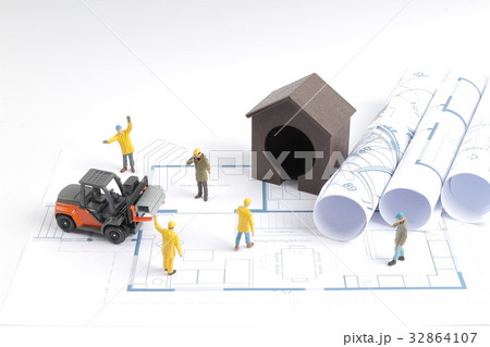 building house on blueprints with worker building house on blueprints with worker 32864107