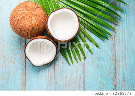 Coconut and green leaf on old wood background. Coconut and green leaf on old wood background. 32865278