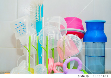 Washed baby bottles on plastic drying rack 32867181