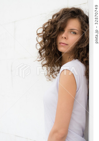 Young attractive woman with curly brown hair Young attractive woman with curly brown hair 32870749