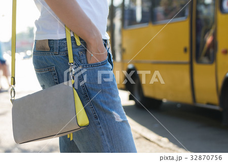 Young woman waiting for a bus at the bus stop Young woman waiting for a bus at the bus stop 32870756