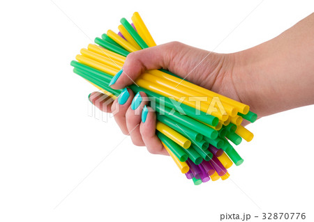 Colored tubules for a cocktail in a female hand Colored tubules for a cocktail in a female hand 32870776