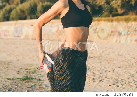 Woman in sportswear doing exercises Woman in sportswear doing exercises 32870933