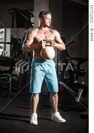 Muscular bodybuilder guy doing exercises with Muscular bodybuilder guy doing exercises with 32871142