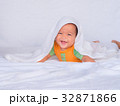 Asian infant lie on the stomach under white towel. 32871866