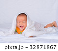 Asian infant lie on the stomach under white towel. 32871867