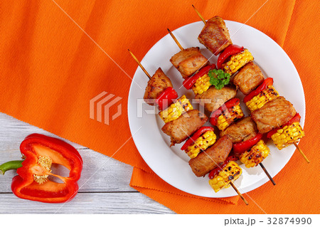grilled pork meat with pieces of corn cobs 32874990