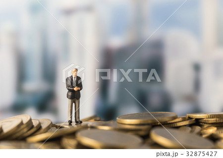 miniature model of investor standing on coin miniature model of investor standing on coin 32875427