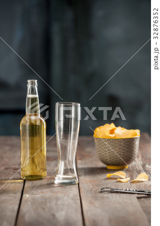 Beer glass and potato chips, pistachios isolated Beer glass and potato chips, pistachios isolated 32876352