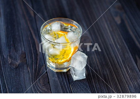 Lemonade with ice cubes and slice of orange 32879896